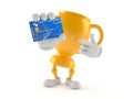 Golden trophy character holding credit card