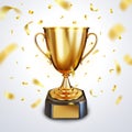 Golden trophy cup or champion cup with a blank gold plate for your text and falling shiny golden confetti Royalty Free Stock Photo