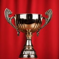 Golden trophy cup over red background Royalty Free Stock Photo