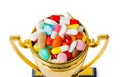 Golden trophy cup with pills