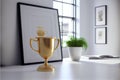 Golden trophy cup on wooden table in modern office