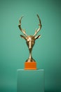 a golden trophy with a deers head on it