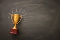 golden trophy over blackboard background. top view. flat lay. Royalty Free Stock Photo