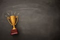 golden trophy over blackboard background. top view. flat lay Royalty Free Stock Photo
