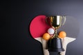 Golden trophy, Racket table tennis with ping pong ball on black Royalty Free Stock Photo