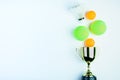 Golden trophy, Shuttlecock, Ping pong ball and Tennis ball isolated on white background with copy space.Concept winner