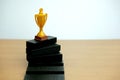 Golden trophy standing on black podium Royalty Free Stock Photo