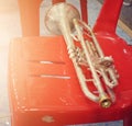 Golden trumpet instrument Put on a red chair