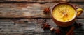 Golden turmeric latte with spices on wooden background a healthy vegan drink with antiviral