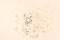 Golden various sizes stars confetti on beige background Royalty Free Stock Photo