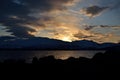Golden vibrant sunset over snowy mountain and fjord Royalty Free Stock Photo