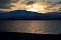 Golden vibrant sunset over snowy mountain and fjord Royalty Free Stock Photo