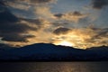 Golden vibrant sunset over snowy mountain and fjord Royalty Free Stock Photo