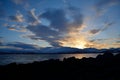 Golden vibrant sunset over snowy mountain and fjord landscape Royalty Free Stock Photo