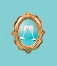 Golden vintage frame on a teal background with two champagne glasses. Royalty Free Stock Photo