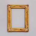 Golden vintage picture frame on a wall. Royalty Free Stock Photo