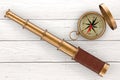 Golden Vintage Telescope Spyglass with Compass over Wooden Table