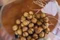 Golden walnut in a glass round vase.