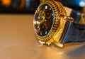 Golden watch putted on the table Royalty Free Stock Photo
