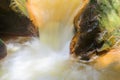 Water streams, orange sand with sediments below. river with red stones Royalty Free Stock Photo