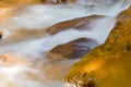 Water streams, orange sand with sediments below. river with red stones Royalty Free Stock Photo