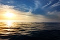 Golden waves at calm sea with dramatic clouds in the sky