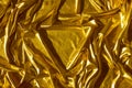 Golden wavy abstract background from a luxurious fabric, wavy folds, in the center a place for your gift in the form of