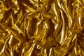 Golden wavy abstract background. Background of luxurious fabric.