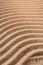 Golden wavy sand texture pattern structure, lit by morning sun. Sand dunes background Royalty Free Stock Photo