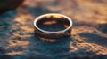 Golden wedding band reflecting light on a stone surface in warm evening glow Royalty Free Stock Photo