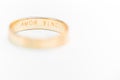 Golden wedding ring isolated on white - amor vincit omnia engraved