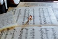 Golden wedding ring on old sheet music, casting a heart shaped shadow. Royalty Free Stock Photo