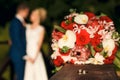 Golden wedding rings on the background of a wedding bouquet of red roses Royalty Free Stock Photo