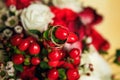 Golden wedding rings on the background of a wedding bouquet of red roses Royalty Free Stock Photo