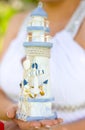 Golden wedding rings on decorative wooden lighthouse with anchor, fishing net and rope