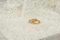 Golden wedding rings with embroidered lace