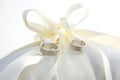 Golden wedding rings laying on ring pillow Royalty Free Stock Photo