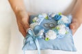 Golden wedding rings on small blue and Turquoise cushion Royalty Free Stock Photo