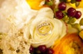 Golden wedding rings on wedding bouquet of yellow flowers and berries Royalty Free Stock Photo