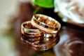 Golden wedding rings and white roses. Royalty Free Stock Photo