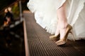 Golden wedding shoes from white dressed bride