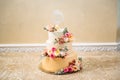 Golden wedding three-story cake. Close-up of a delicious dessert decorated with flowers, wedding cake decor. Copy space Royalty Free Stock Photo