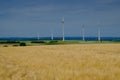 Golden wheat field and wind turbines Royalty Free Stock Photo