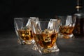 Golden whiskey in glasses with ice cubes