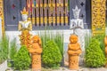 Golden and white angels and orange little monks statues are act paying respect to welcome to the public Buddhist temple. Thai styl Royalty Free Stock Photo