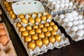 Golden, white, brown eggs in a tray for sale at a farmer\'s market for Easter, success, prosperity concept Royalty Free Stock Photo