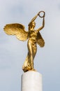 Golden winged goddess woman holding wreath is a top part of the monument Fallen Heroes of Macedonia, located in the Zena Borec