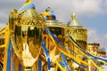 Golden winner's cups with yellow and blue ribbons prepared for awards in a row on the table on sky background Royalty Free Stock Photo