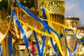 Golden winner's cups with yellow and blue ribbons prepared for awards in a row on the table on sky background Royalty Free Stock Photo