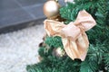 Golden winter decorations hanging on Christmas tree. Holiday and celebration creative concept. Royalty Free Stock Photo